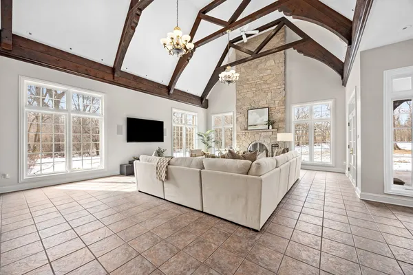 a dining room with furniture a chandelier and wooden floor