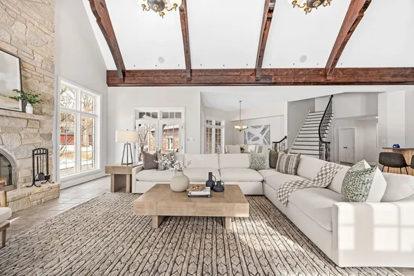 a dining room with wooden floor a chandelier a wooden table and chairs