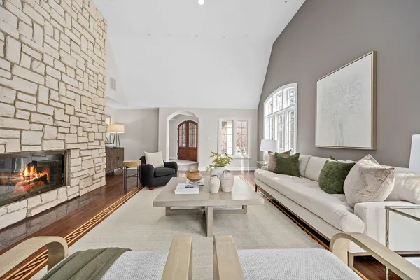 a living room with patio furniture and a large window