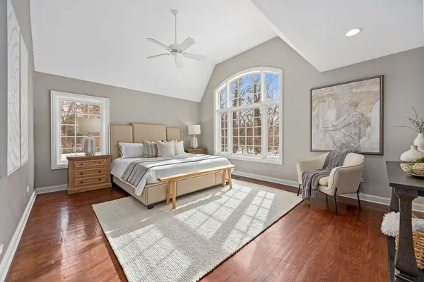 a bedroom with a bed and a chandelier