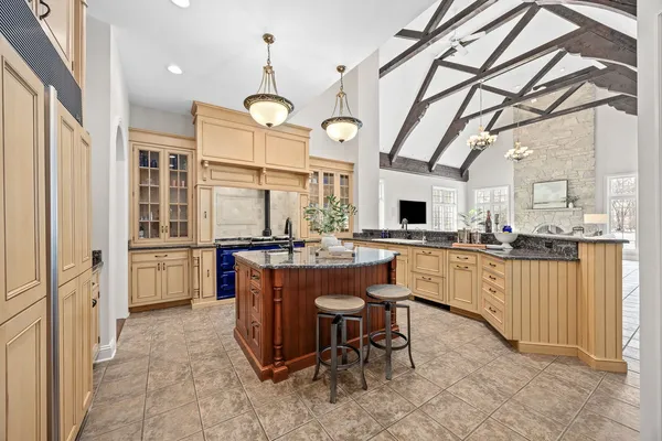 a large kitchen with a table and chairs