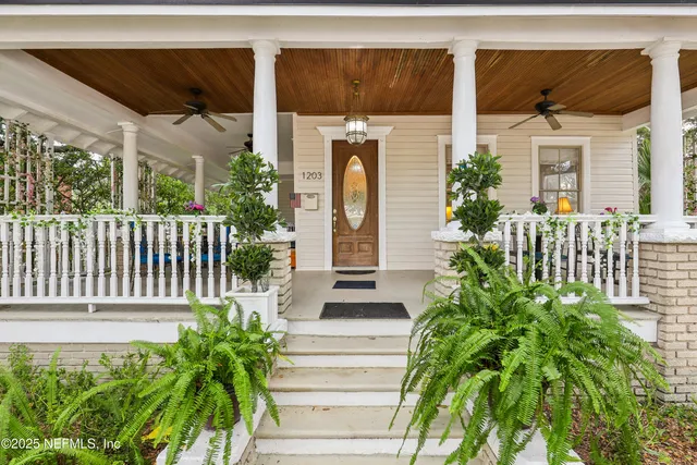 a view of a dining room with furniture a chandelier and wooden floor