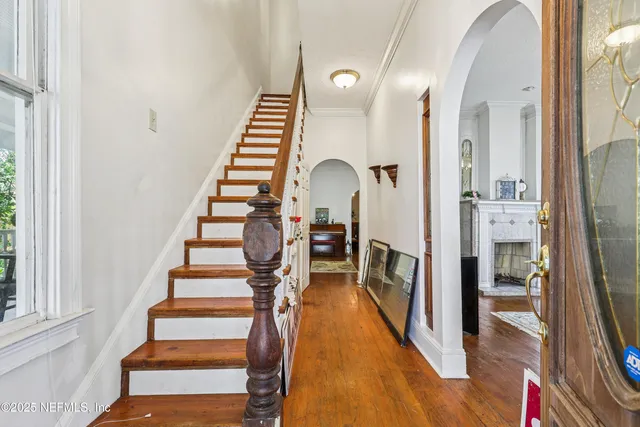 a view of entryway and hall with wooden floor