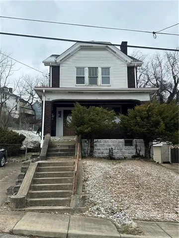 a front view of a house with stairs