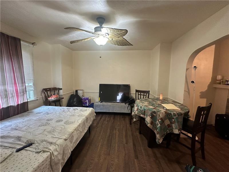 12 Elizabeth Street Pittsburgh, PA 15210 - Photo 11 of 32 a bedroom with bed and a chandelier