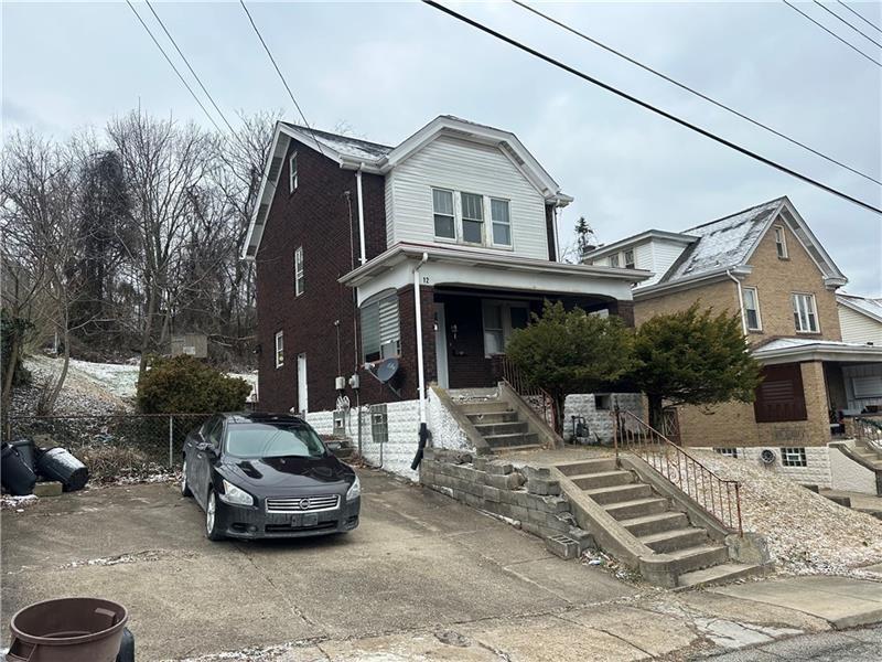 12 Elizabeth Street Pittsburgh, PA 15210 - Photo 2 of 32 a car parked in front of a white house