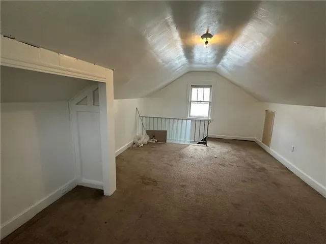 an empty room with a ceiling fan and a window