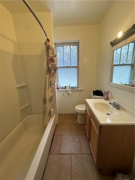 12 Elizabeth Street Pittsburgh, PA 15210 - Photo 26 of 32 a bathroom with a sink and mirror with bathtub