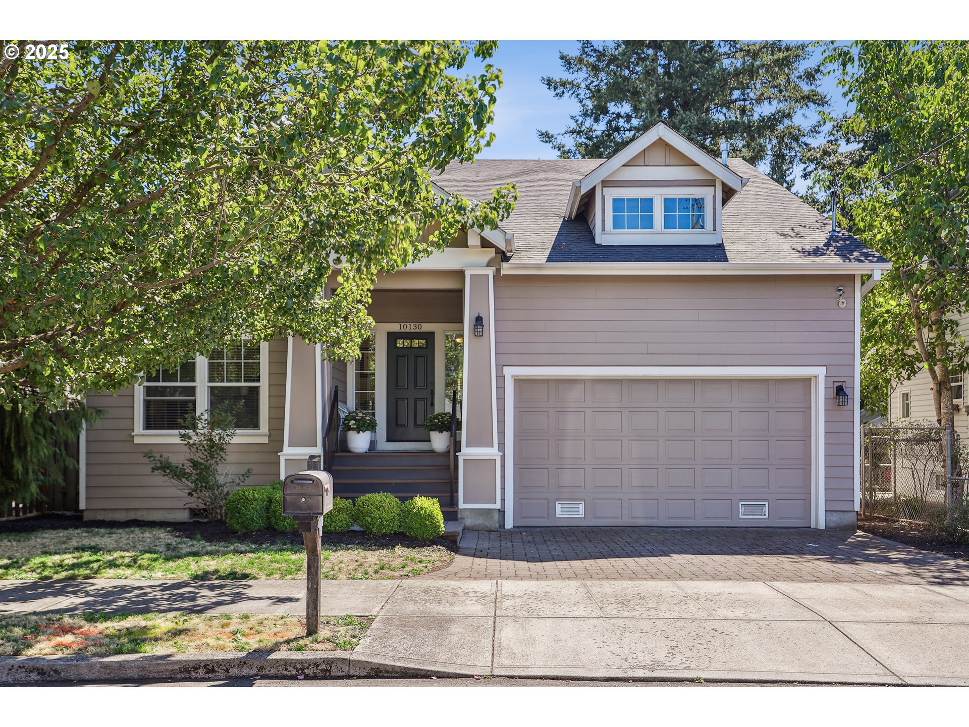 10130 Southeast Knight Street Portland, OR 97266 - Photo 2 of 33 a front view of a house with garden