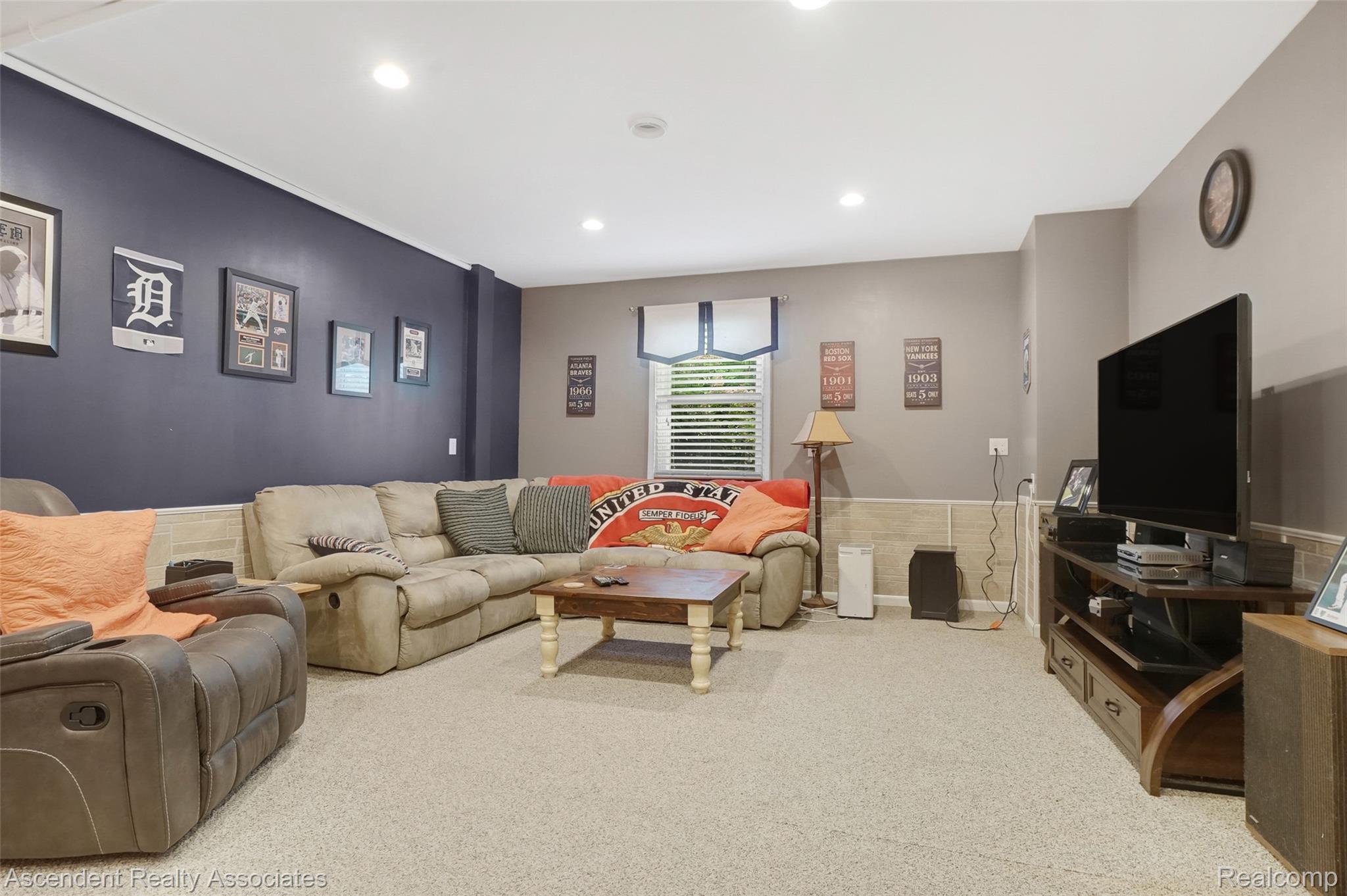 6157 Blue Beech Court Rochester, MI 48306 - Photo 18 of 30 1st Floor Rec Room. Located just off the Mud room and or Kitchen. Featuring recessed lighting illuminates this room with neutral-toned carpeting, a partial dark accent wall, and a window with horizontal blinds