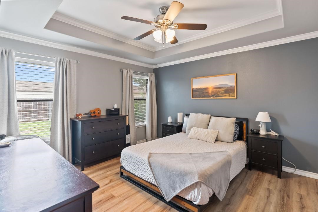 4328 Bratton Road Corpus Christi, TX 78413 - Photo 11 of 24 a bedroom with a bed and a chandelier