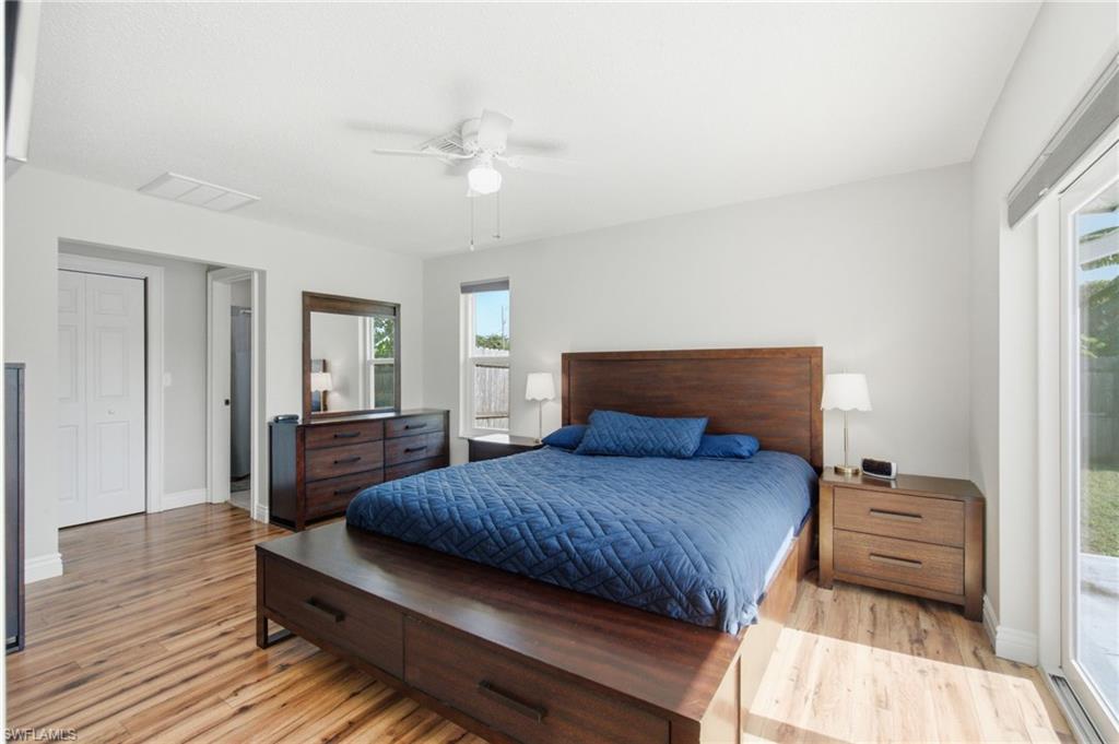 3022 47th Street Southwest Naples, FL 34116 - Photo 25 of 46 Spacious bedroom featuring wood-finish flooring, white walls, and a ceiling fan