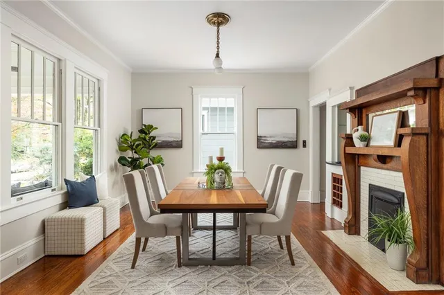 a kitchen with stainless steel appliances a dining table chairs refrigerator and sink