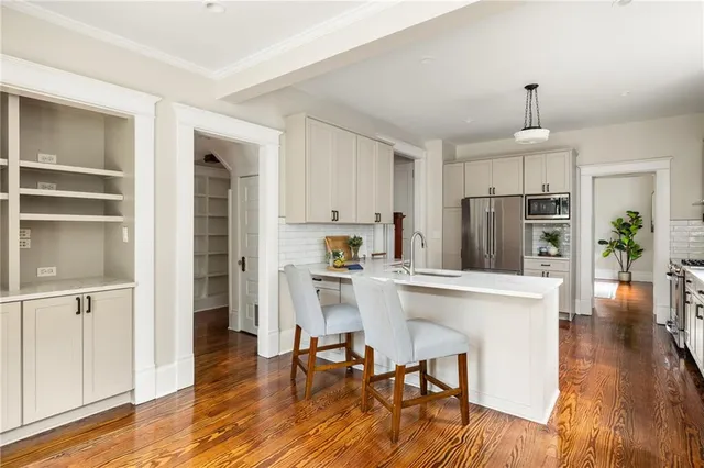 a view of entryway and hall with wooden floor
