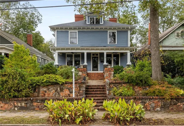 a living room with furniture a fireplace and a window