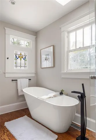 a bedroom with a bed and a dresser next to a window