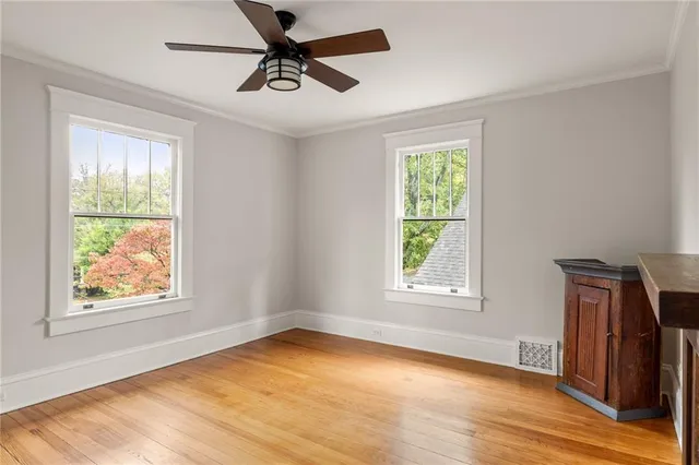 a living room with patio furniture and a potted plant