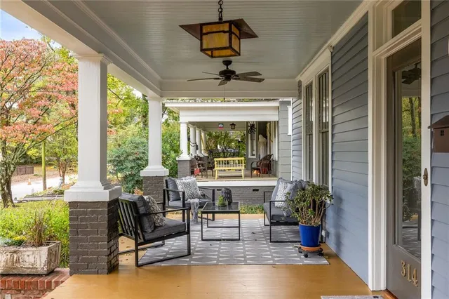 a living room with furniture potted plant and a window