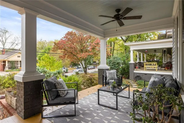 a living room with furniture a fireplace and a potted plant