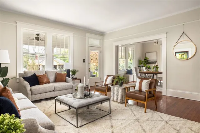 a room with wooden floor and a potted plant