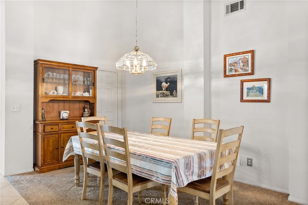 944 Riverview Drive Redlands, CA 92374 - Photo 12 of 32 a dining room with furniture a chandelier and wooden floor