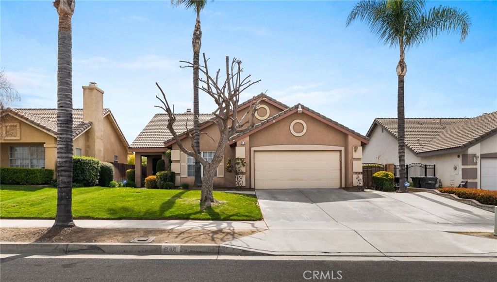 944 Riverview Drive Redlands, CA 92374 - Photo 3 of 32 a front view of a house with a garden and trees