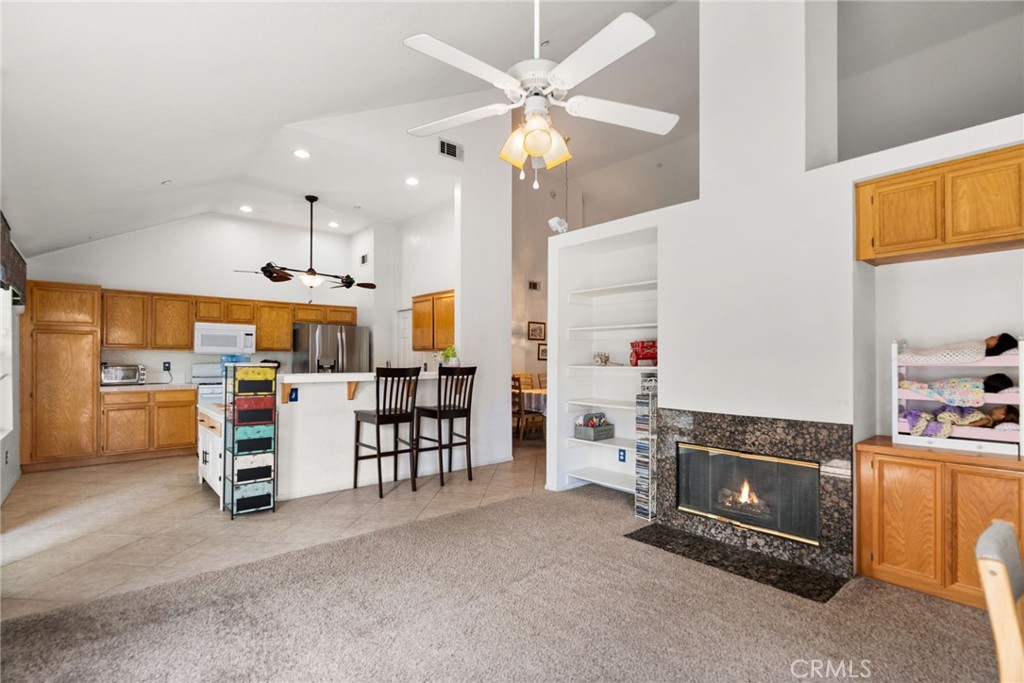944 Riverview Drive Redlands, CA 92374 - Photo 5 of 32 a kitchen with stainless steel appliances kitchen island granite countertop a refrigerator and a stove top oven
