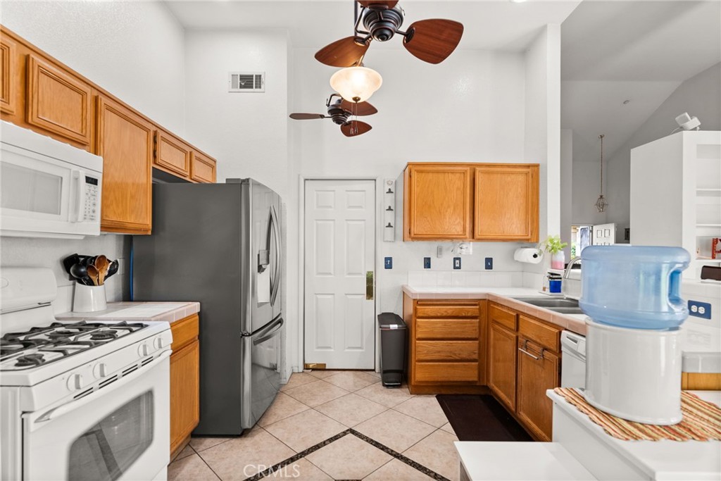 944 Riverview Drive Redlands, CA 92374 - Photo 10 of 32 a kitchen with a refrigerator and a stove top oven