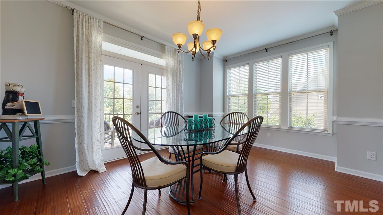 1329 Rembrandt Circle Raleigh, NC 27607 - Photo 11 of 23 a dining room with furniture potted plants and wooden floor