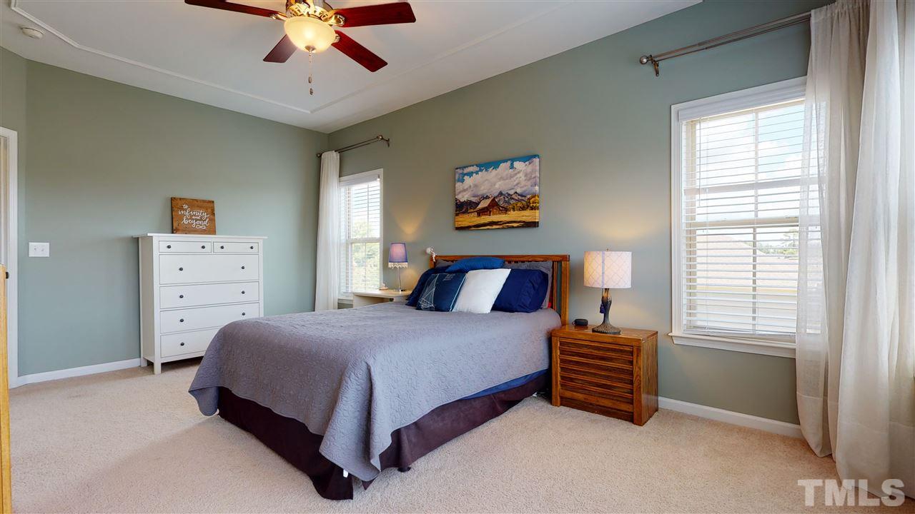 1329 Rembrandt Circle Raleigh, NC 27607 - Photo 13 of 23 a bedroom with a bed and a chandelier