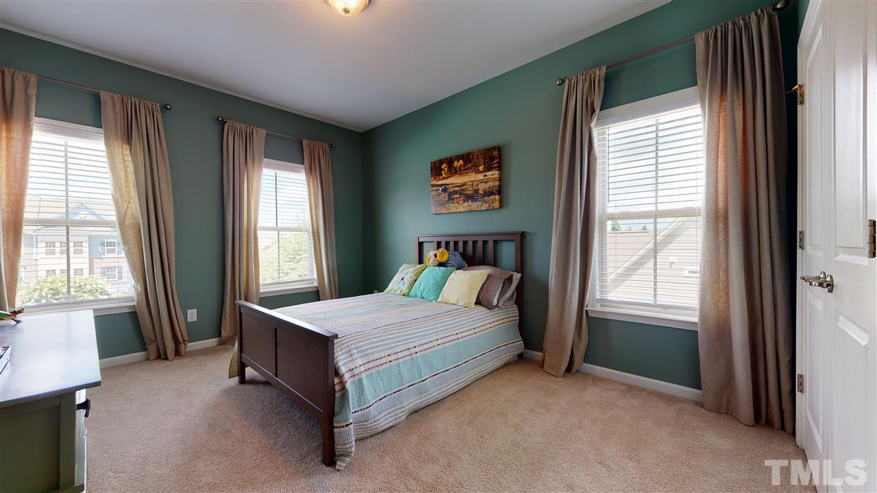 1329 Rembrandt Circle Raleigh, NC 27607 - Photo 17 of 23 a bed sitting in a bedroom next to a window