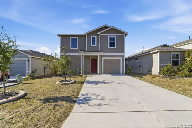 a front view of a house with yard