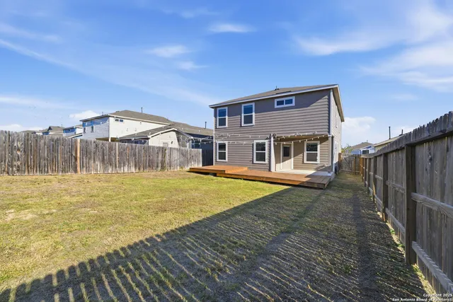 a view of a house with a backyard