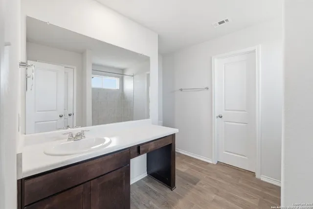 an empty room with closet and fan