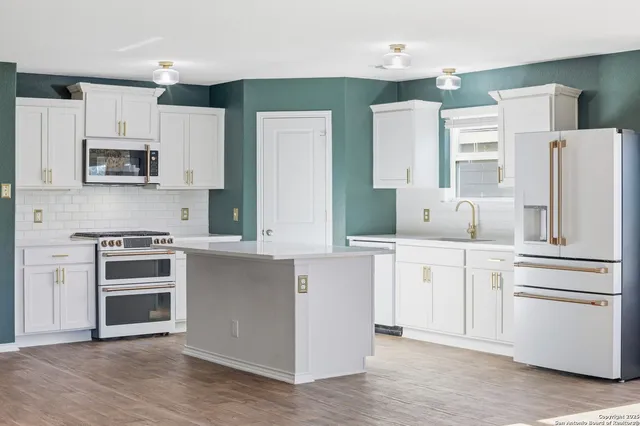 a kitchen with a sink and cabinets