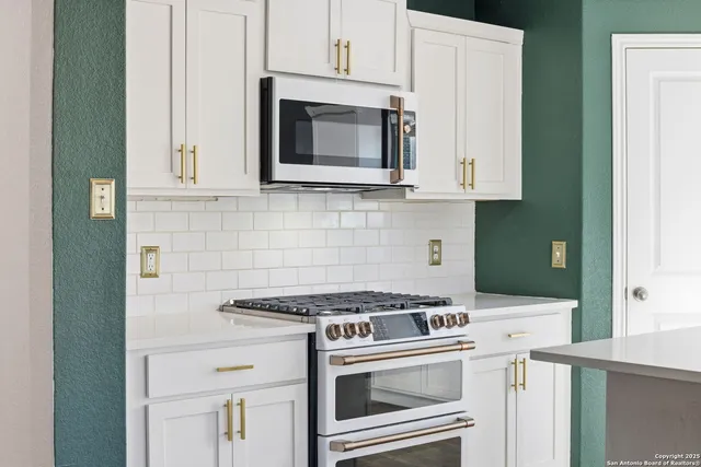 a view of kitchen with sink and refrigerator