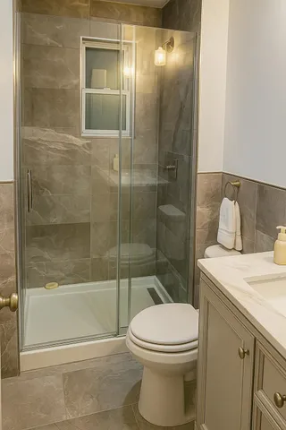 a bathroom with a toilet and a shower