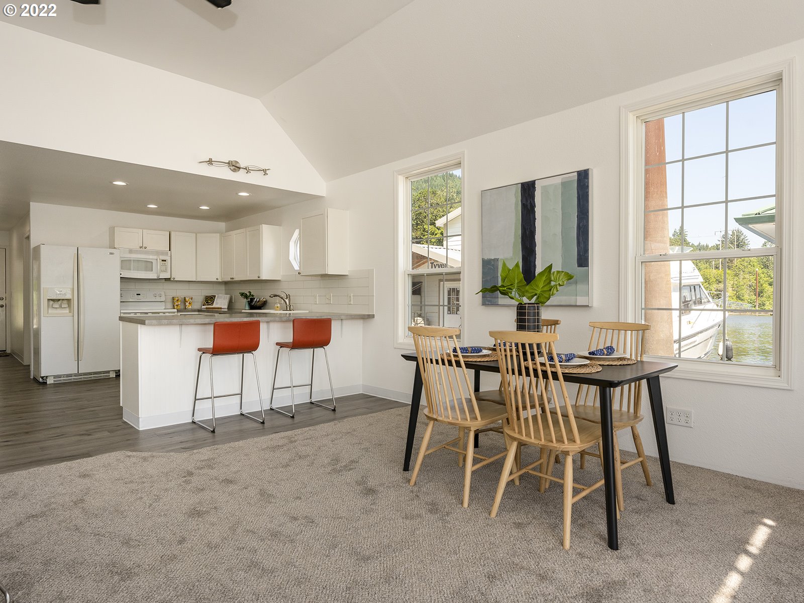 23560 Northwest St Helens Road, Unit N4 Portland, OR 97231 - Photo 15 of 27 a kitchen with stainless steel appliances kitchen island granite countertop a table and chairs in it