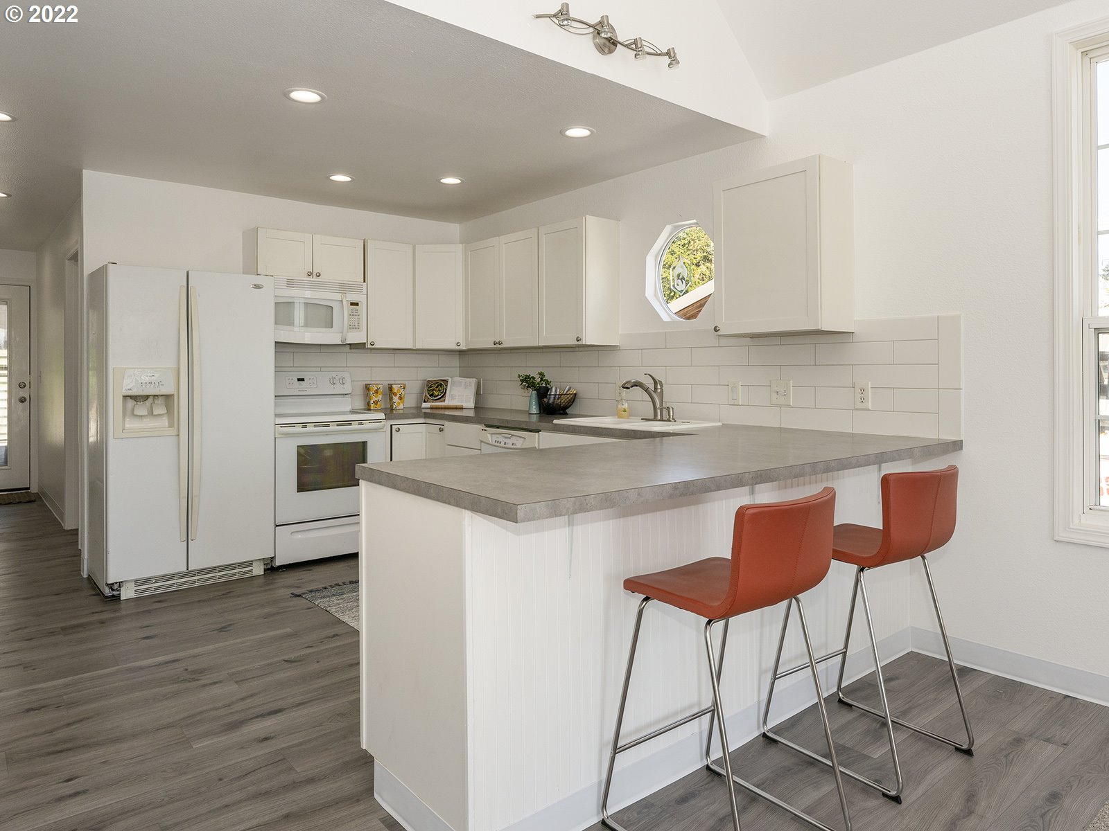 23560 Northwest St Helens Road, Unit N4 Portland, OR 97231 - Photo 17 of 27 a kitchen with stainless steel appliances granite countertop a refrigerator and a stove top oven