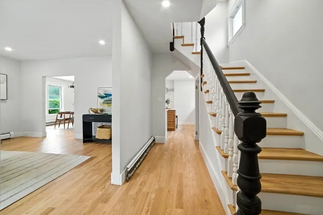a view of entryway and hall with wooden floor