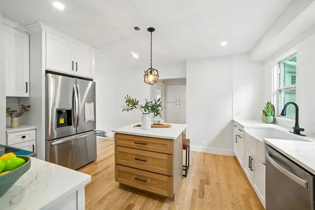 a kitchen with stainless steel appliances a sink stove and refrigerator
