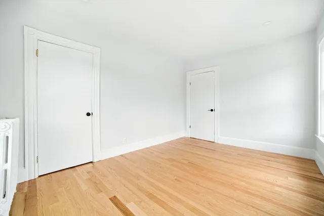 a view of a room with wooden floor