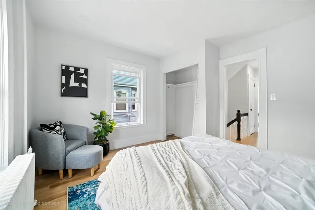 a bedroom with a bed and a chair