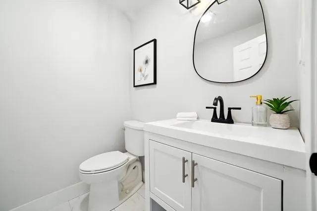 a bathroom with a sink a mirror and a toilet
