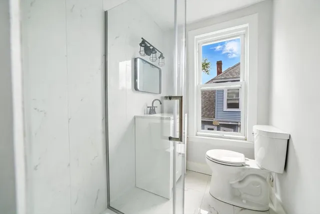 a white toilet sitting next to a bathroom sink
