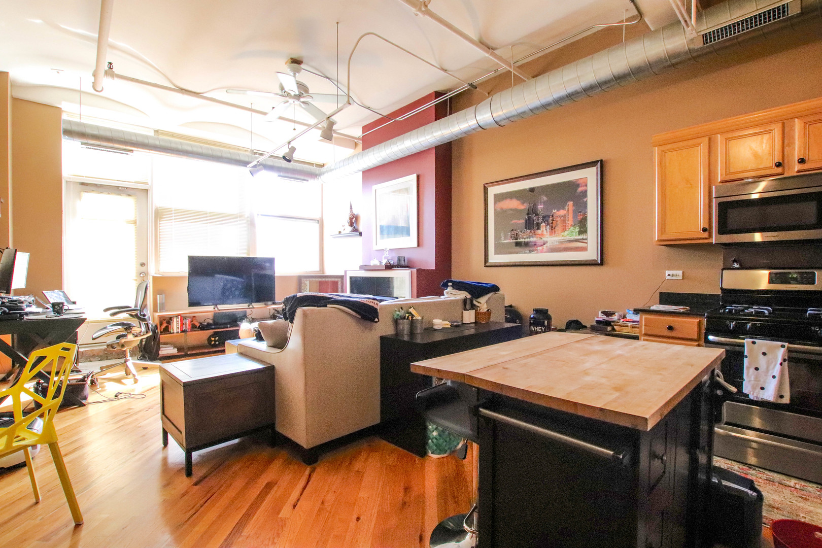500 South Clinton Street, Unit 311 Chicago, IL 60607 - Photo 3 of 9 a view of a dining room with furniture window and wooden floor