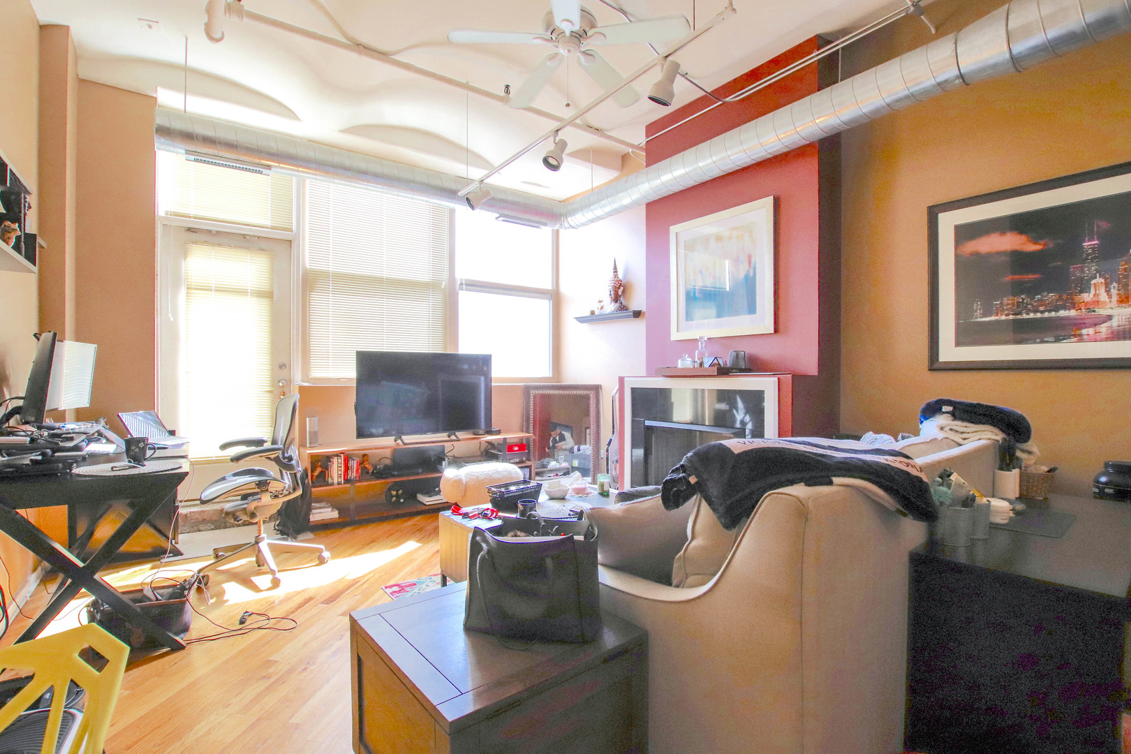 500 South Clinton Street, Unit 311 Chicago, IL 60607 - Photo 4 of 9 a work room with furniture large window and wooden floor