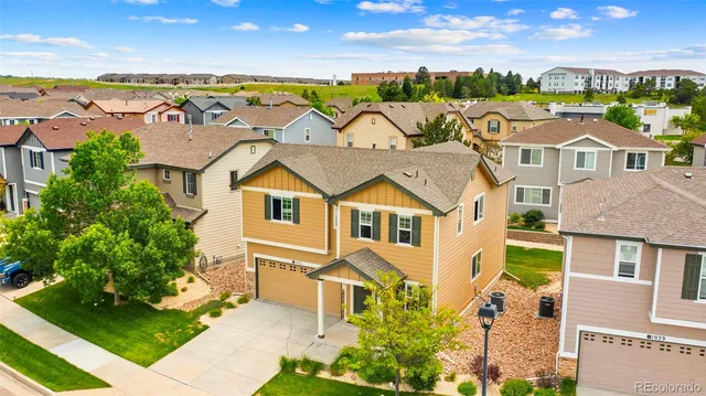 an aerial view of residential houses with outdoor space and ocean view