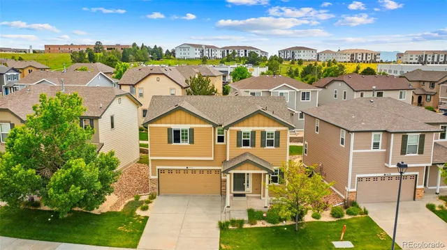 an aerial view of residential houses with outdoor space and lakeside