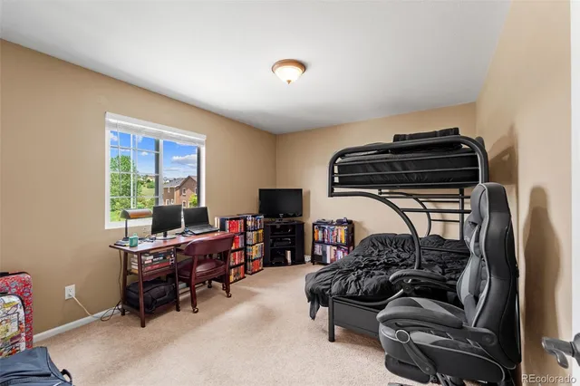 a bedroom with furniture and a window